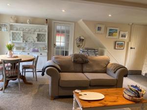 a living room with a couch and a table at The Studio Gressingham in Hornby