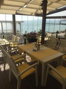 a patio with tables and chairs and the ocean at White House Family Hotel Spa zone in Balchik