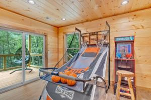 a cabin with a trampoline in a room at Sneaky Bear in Sevierville