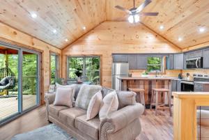 a living room with a couch and a kitchen at Sneaky Bear in Sevierville
