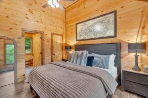 a bedroom with a bed in a room with wooden walls at Sneaky Bear in Sevierville