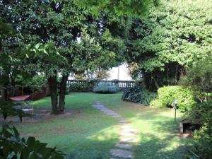 a garden with trees and grass and a pathway at Parco Hermitage - Villa Azalea in Porto Valtravaglia