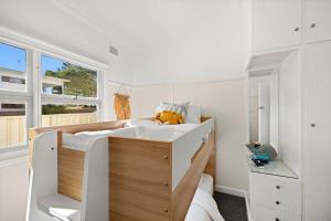 a bedroom with a bed with a teddy bear on it at Garrys After Dunes Delight in Norah +14 photos
