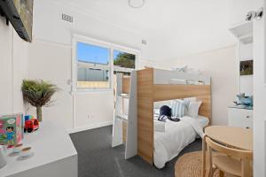 a bedroom with a bunk bed and a table at Garrys After Dunes Delight in Norah
