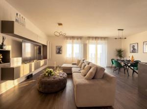 a living room with a couch and a table at Design Penthouse with Balcony - Iseo in Iseo