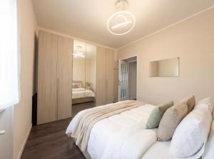 a bedroom with a large white bed in a room at Design Penthouse with Balcony - Iseo in Iseo