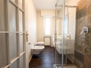 a bathroom with a toilet and a sink at Design Penthouse with Balcony - Iseo in Iseo