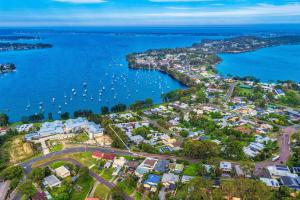 an aerial view of a harbor with boats in the water at Wangi Waters and Views in Wangi Wangi +9 photos