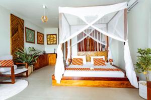a bedroom with a bed with a canopy at Zanzibella Hotel & SPA in Kiwengwa