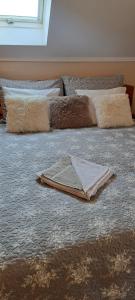 a bed with pillows and a towel on it at Villa Maria in Egerszalók +3 photos