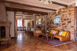 a living room with couches and a stone wall at Villa Montegenco B&B in Comunanza