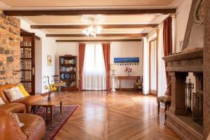 a living room with a couch and a fireplace at Villa Montegenco B&B in Comunanza +18 photos