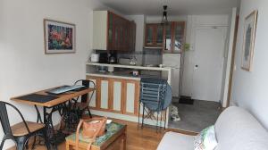 a small kitchen with a table and a counter top at cote d'armor in Plestin-les-Grèves