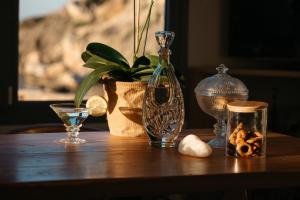 a table with a vase and other items on it at Irini's Beach House in Ambrami