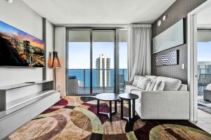 a living room with a couch and a large window at 3BR Oceanview HYDE - Free Parking, No Resort Fee in Hollywood