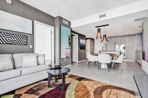 a living room with a couch and a table at 3BR Oceanview HYDE - Free Parking, No Resort Fee in Hollywood