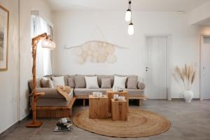 a living room with a couch and a coffee table at Irini's Beach House in Ambrami +32 photos