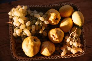 a basket filled with fruits and vegetables on a table at Irini's Beach House in Ambrami