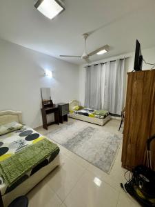 a living room with two beds and a desk at Farno Hostel in Muscat +3 photos