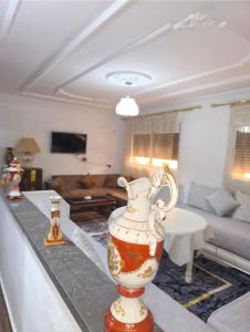 a vase sitting on a counter in a living room at إقامة الكرنيش in Nador