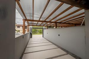 a hallway of a house with white walls and a ceiling at Alto padrão, 2 suítes e lazer privativo in Joinville
