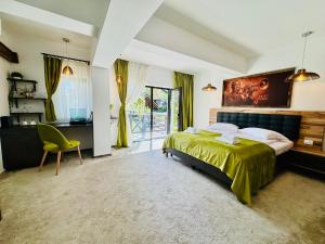 a bedroom with a bed and a desk and a chair at Jazz House in Voroneţ