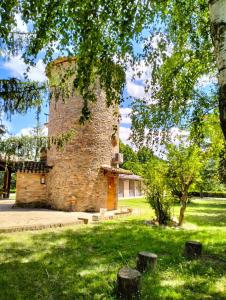 a brick building in the middle of a park at Villa Montegenco B&B in Comunanza