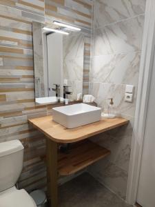 a bathroom with a white sink and a toilet at cote d'armor in Plestin-les-Grèves