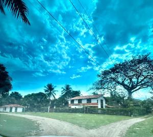a house on the side of a dirt road at El Encanto in Olaya