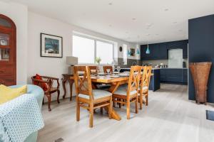 a kitchen and dining room with a table and chairs at Middle Chine - Beautiful Garden and Spacious Living Space in Bournemouth
