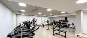 a gym with several tread machines in a room at Metra DS Puerto Norte in Rosario