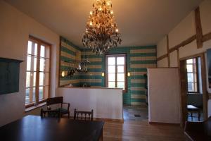 a dining room with a table and a chandelier at Der Schwan - Gutshaus Bückling in Rambin