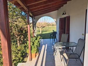 a patio with a table and chairs on a porch at tragano in Traganón +25 photos