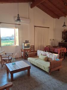a living room with a couch and a table and a tv at tragano in Traganón
