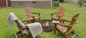 two chairs and a fire pit in a yard at Creekside Retreat by Beyond Expectations in Pigeon Forge