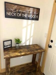 a wooden table with a sign on the wall at Creekside Retreat by Beyond Expectations in Pigeon Forge +51 photos