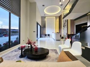 a living room with a couch and a table at Modera Residence Grand Phnom Penh, Serviced Apartments in Phnom Penh