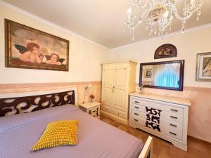 a bedroom with a bed and a dresser and a chandelier at Art & Relax House in Gallipoli