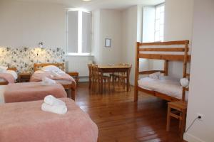 a room with four beds and a bunk bed at Le grand couvent de Gramat in Gramat