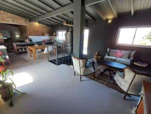 a living room with a couch and a table at Luxurious and spacious 2 level apartment in Tygerberg Hills