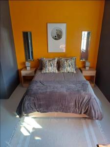 a bedroom with a large bed with two night stands at Luxurious and spacious 2 level apartment in Tygerberg Hills