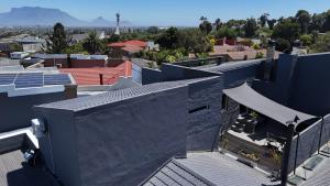 a view of the roofs of a building at Luxurious and spacious 2 level apartment in Tygerberg Hills
