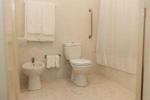 a white bathroom with a toilet and a bidet at Northern Breeze Comfort in Ribeira Grande +32 photos