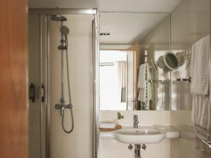 a bathroom with a shower and a sink and a mirror at Casa Solayme Garrett in Lisbon +62 photos