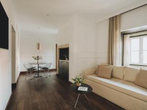 a living room with a couch and a table at Casa Solayme Garrett in Lisbon