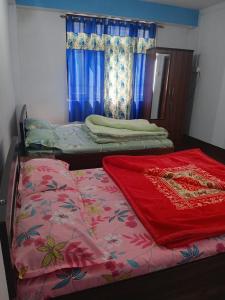 a bedroom with two beds and a window at Aashirwad homestay in Aritar