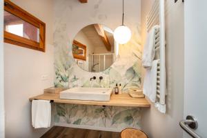 a bathroom with a sink and a mirror at Hotel Boutique Niu de Sol - Designed for Adults in Palau-Saverdera +67 photos