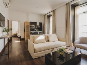 a living room with a couch and a table at Casa Solayme Garrett in Lisbon