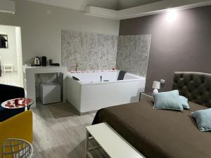a bedroom with a bed and a bath tub at Due Delfini in Taranto