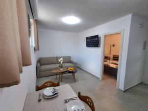 a small living room with a table and a couch at Villa Oxana in Limenas